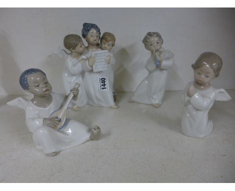 Four Lladro figurines - angels singing, angels kneeling, angels with a pipe and angels with a guitar - all in good condition