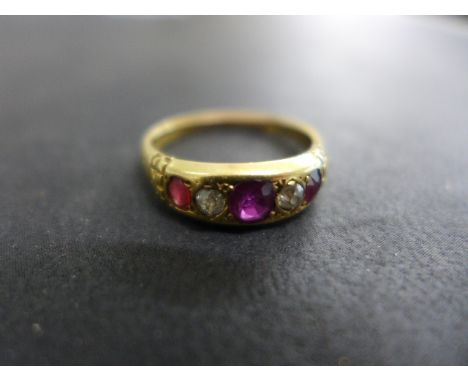 An 18ct yellow gold diamond and ruby ring size R - some usage wear, signs of rebuilding shank - weight approx 3.8 grams