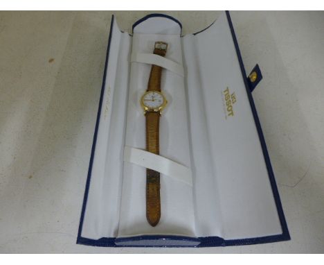 An 18ct gold cased Tissot watch, baton markers to white dial, date aperture at 3 o'clock, centre sweep seconds - requires new
