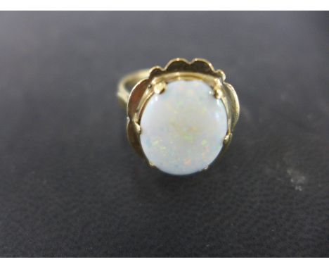 A 9ct yellow gold ring set with oval opal to shoulder - ring size V - approx weight 5.5 grams - clean and bright