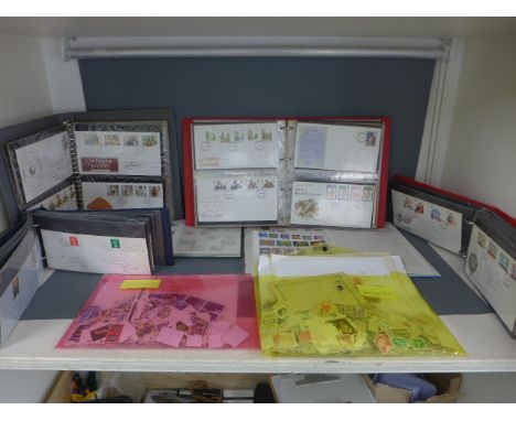 An album containing modern British stamps and one of World stamps, a folder of loose modern British stamps, a folder of loose