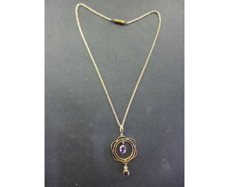 An Edwardian style gold amethyst and seed pearl pendant - tested as 14ct gold, mounted on a short chain, length 32cm, also te