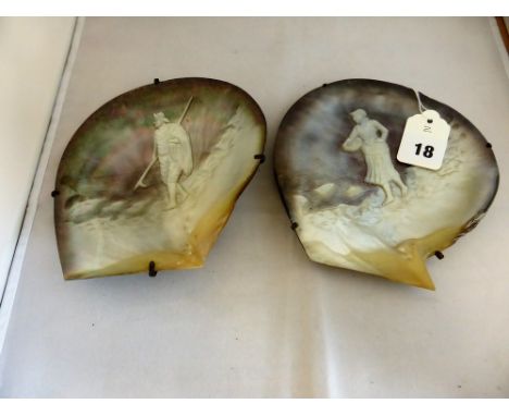 A pair of antique Mother of Pearl shell carvings depicting a fisherman walking along a seashore and a fisher wife collecting 