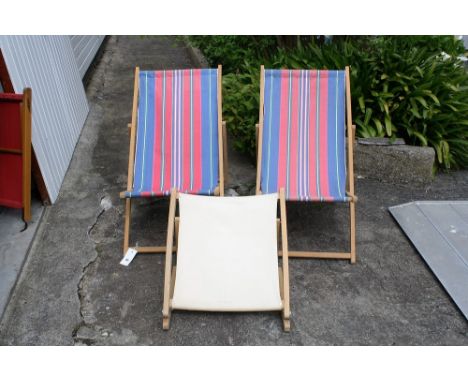 Two vintage deck chairs with original stripped canvas, one with foot rest.* Please Note: A further 500 lots from this sale (w