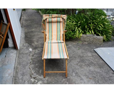 A vintage steamer lounger sun bed deck chair with foot rest & shade cover, original striped canvas.* Please Note: A further 5