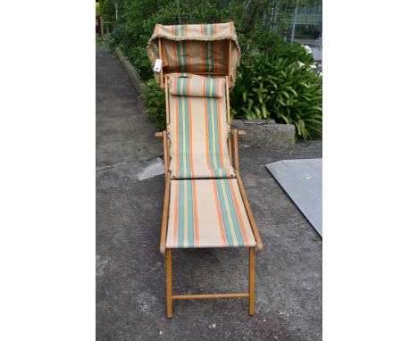 A vintage steamer lounger sun bed deck chair with foot rest & shade cover, original striped canvas.* Please Note: A further 5