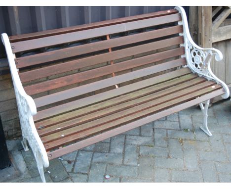 A Victorian style cast iron ended and stained teak slatted two-seater garden bench, w.127cm