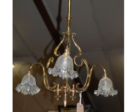 An Art Nouveau lacquered brass three light ceiling pendant, having clear crackle glass shades with folding rims, h.92cm   Con