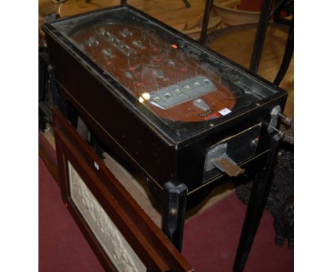 A mid-20th century freestanding ebonised bagatelle table