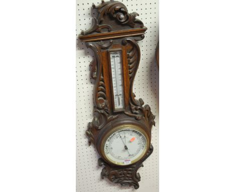 An early 20th century carved oak two-dial aneroid wheel barometer by Potts & Sons of Leeds 
