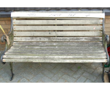 A pierced cast iron ended and teak slatted two-seater garden bench, w.125cm