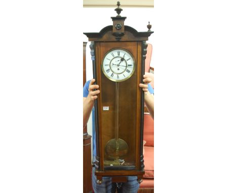 A late 19th century walnut and ebonised Vienna wall clock, having brass mounted white enamel dial (with hairlines), subsidiar
