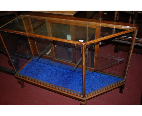 A late Victorian oak and glazed shop display cabinet, having twin rear glazed sliding doors, enclosing single shelf interior,