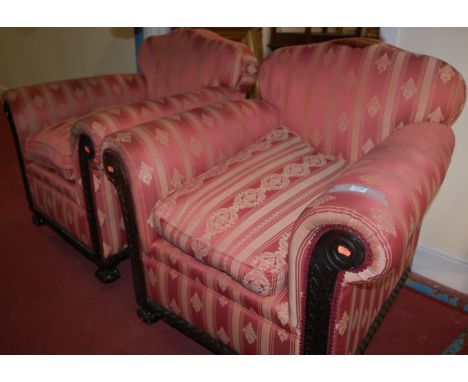 An early 20th century mahogany and red floral striped upholstered three piece suite comprising; three seater triple humpback 