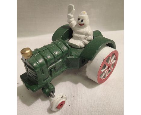Cast iron Michelin Man on a tractor, 10 x 8 cm. P&amp;P Group 1 (£14+VAT for the first lot and £1+VAT for subsequent lots) 