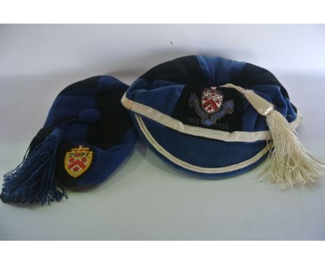 A vintage lined felt school peaked cap with a white tassel decorated in concentric black and blue colourway with white banded