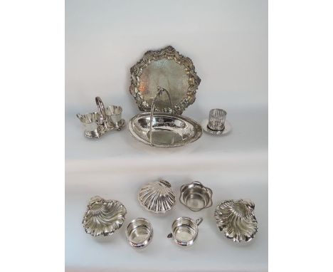 A silver plated tray of circular form with pie crust border, decorated with embossed shell and scrolling detail with further 