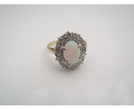 An opal and diamond ring, centred with an oval cabochon opal weighing approximately 0.84cts, the textured bezel set with ten 