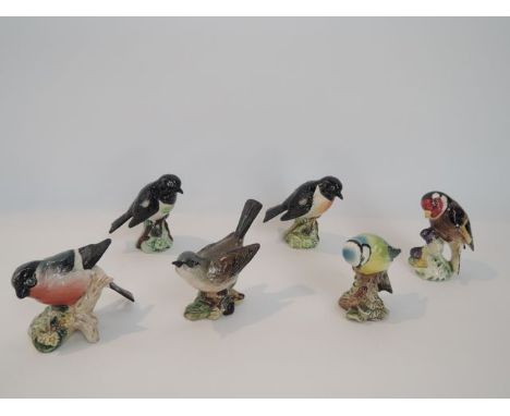 A collection of six Beswick model birds including a Blue Tit 992, a Goldfinch 273, a White Throat 2106,  a Bullfinch 1042 and