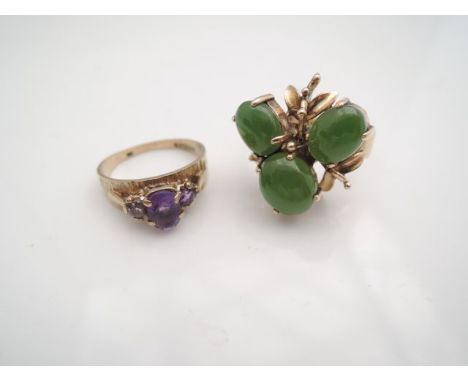 A jade ring, claw-set with three oval cabochon jade stones, highlighted with stylised leaves, in 18ct gold, size O; and an am