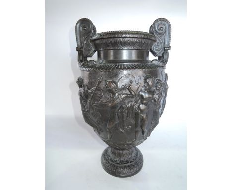 A substantial cast metal urn of classical form with scrolling applied handles and central decoration in deep relief depicting