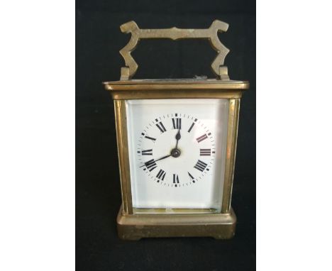 A French brass carriage clock by Duverday & Bloquel with enamel dial and 8 day timepiece