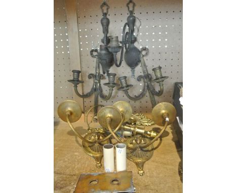A selection of brass and cast metal lighting effects to include a pair of two divisional wall sconces, the candlesticks with 