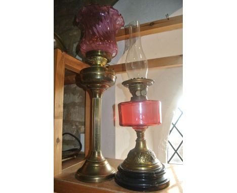 An early 20th century brass oil lamp in the form of a fluted column upon a circular stepped base, supporting burner,  marked 