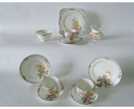 A six place Tuscan China six place Yuan pattern tea service with stylised floral decoration comprising milk jug, sugar bowl, 