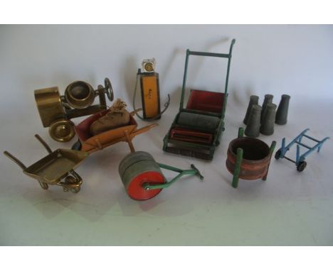 A selection of vintage, mostly die cast, industrial and garden figures to include a lawn roller/cutter with red painted blade