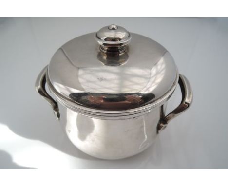 A French silver sugar bowl and cover, 950 standard, the bulbous body applied with two scrolling handles, the removable cover 