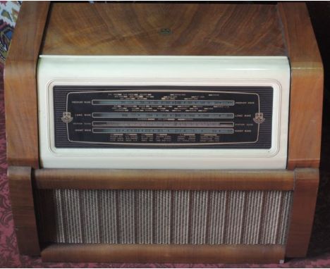 A vintage Regentone Multi 99 Auto Table Radio-Gramophone set within a veneered case of rectangular form with cream coloured B