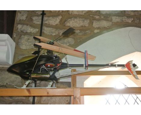 A substantial Thunder Cat Pro remote control model petrol fuelled helicopter, marked JK0051 to the timber blades, fitted with