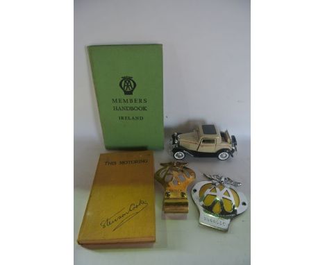 A selection of automobile related items to include a vintage brass Automobile Association badge and a further plated example,