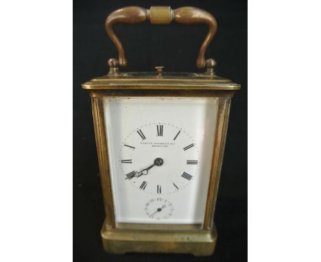 An English brass carriage clock with enamel dial and 8 day striking movement and alarm, the gong marked M.V. - movement 2608