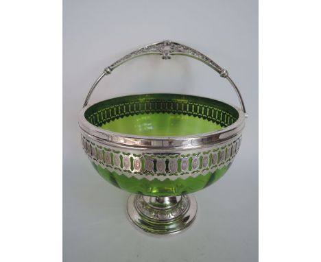 A silver plated pedestal bowl with original green glass liner by WMF, the circular base decorated with repeating oval medalli