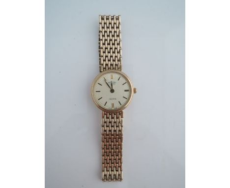 A lady's 9ct gold wristwatch, Rotary, quartz, the textured gilt dial with black enamelled gilt baton numerals, on a 9ct gold 