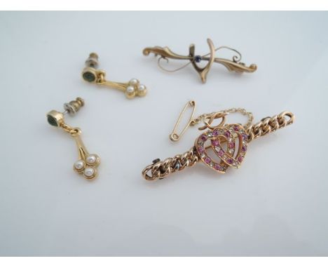 A Victorian sentimental twin heart brooch, each intertwining heart set with rubies and diamonds, on a curb-link bar, in 15ct 