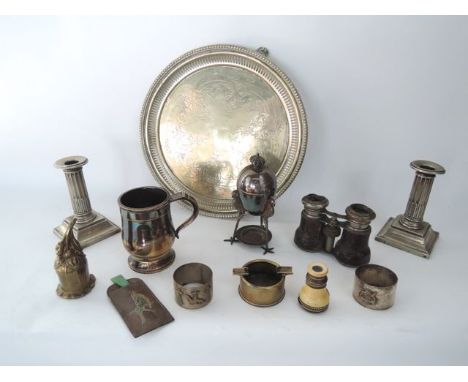A pair of short candlesticks in the form of fluted columns with pill shaped embossed decoration on a stepped square base with