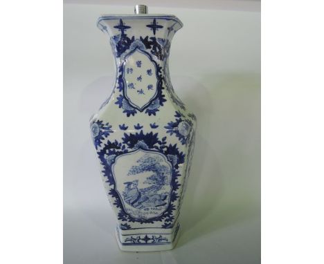 An oriental lamp base with blue and white painted character, bird and floral decoration