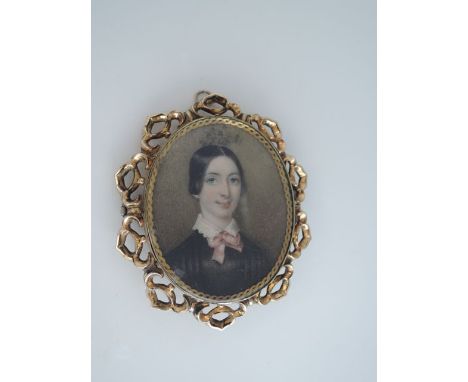 A mid Victorian portrait miniature brooch, of a young lady with white collar and pink bow, in an open worked gold-plated fram