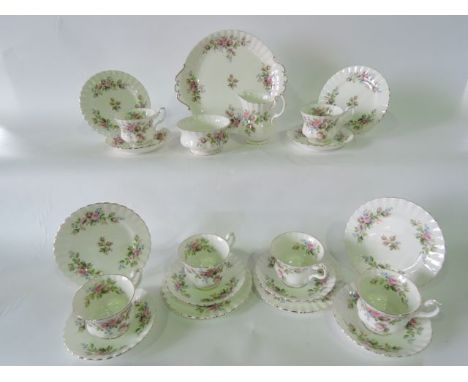 A collection of Royal Albert Moss Rose pattern tea wares comprising a milk jug, sugar bowl, cake plate, six cups, six saucers