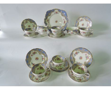 A collection of Paragon China Honiton pattern tea wares comprising milk jug, sugar bowl, cake plate, six cups, six saucers an