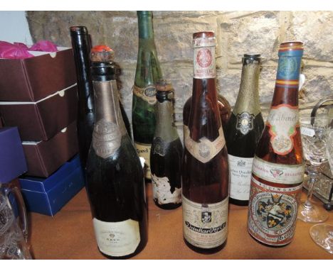 A selection of nine vintage champagne and other glass bottles to include a Bollinger example dated 1953, a Pol Roger bottle w