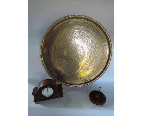 A substantial eastern brass charger of circular form with central embossed star motif, surrounded by trailing bands of furthe