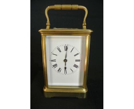 A brass carriage clock by Henri Jacol with enamel dial case. Key and movement all numbered 16598 and real leather travelling 