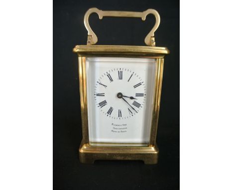 A French brass carriage clock with 8 enamel dial and 8 day time piece retailed by Furber & Son Cheltenham