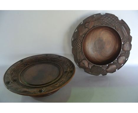 A vintage Swedish carved timber charger with trailing foliate border, with central script reading Lauterbrunnen, the circular