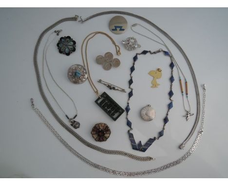 A lapis lazuli and silver necklace, 950 standard, composed of kite-shaped links; a silver bar brooch, centred with an oval mi