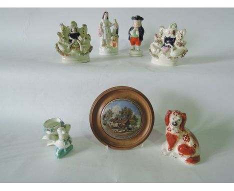 A collection of 19th century ceramics including a pair of Staffordshire figure groups of a boy and a girl accompanied by swan